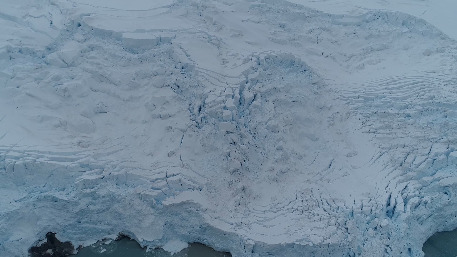 The textured, crevassed surface of the glacier from above