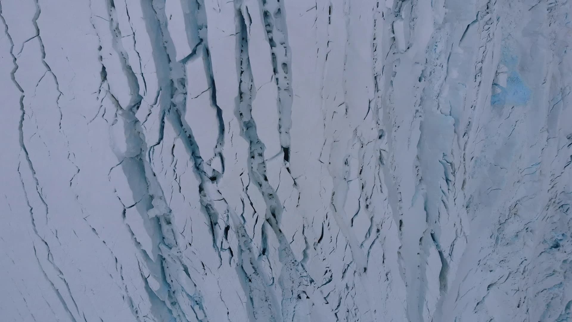 Vertical striations on a steep ice cliff